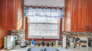A kitchen with a double sink, a coffee maker, a kettle, and various utensils. - Woodstock Getaway w/ Hot Tub ~ 2 Mi to Dtwn! (Woodstock)