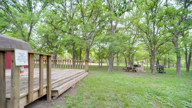 A wooden deck leading to a cabin with a sign warning against open fires. - Winery Cabin in Fredericksburg w/ Wraparound Deck! (Fredericksburg)