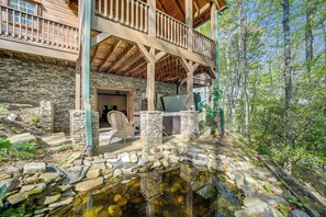 A stone building with a wooden deck and a pond. - Hot Tub & Fire Pit: Secluded Gem in Franklin (Franklin)