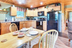 A wooden kitchen with a dining table set for four, a refrigerator, microwave, and stove. - 'fox Den' w/ Hot Tub! 22 Mi to Cataloochee Skiing (Whittier)