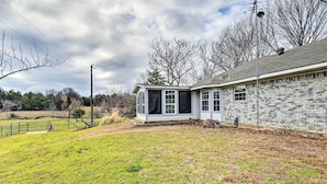 A house with a detached garage, a fenced yard, and a cloudy sky. - Blue Ridge Vacation Rental w/ Game Room! (Blue Ridge)