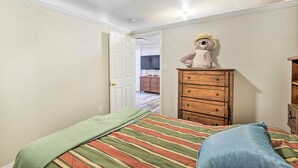 A bedroom with a bed, a dresser, a ceiling fan, and a door leading to another room. - Blue Ridge Vacation Rental w/ Game Room! (Blue Ridge)