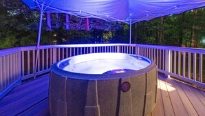 A hot tub on a wooden deck with a canopy overhead. - Charlotte Vacation Rental w/ Private Hot Tub! (Charlotte)