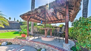 A gazebo with a thatched roof, surrounded by a brick and stone patio, and a pool area. - Vista Home w/ Pool ~ 11 Mi to Tamarack State Beach (Vista)