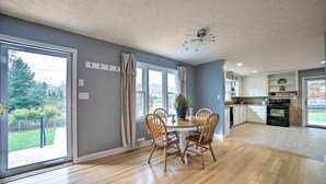 A spacious kitchen with a dining area, large windows, and a view of the outdoors. - Home w/ Yard: 8 Mi to French Broad River Park (Asheville)