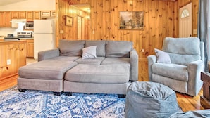 A cozy living room with a sectional sofa, a recliner, and a rug.