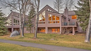 A modern two-story house with large windows and a balcony, surrounded by trees. - Charming Mtn Home on Golf Course ~ 4 Mi to Slopes! (Avon)
