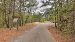 A private road leading into a wooded area with a sign indicating it is private.