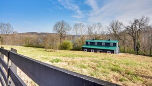 A rural landscape with a green-roofed barn and a fence in the foreground. - 'cumberland Cottage' - 2 Blocks to Downtown Dover! (Dover)