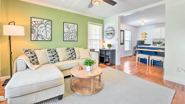 A living room with a sofa, coffee table, and artwork on the wall. - Cozy Bryson City Home w/ Fire Pit & Mtn Views! (Bryson City)