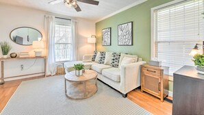 A living room with a ceiling fan, a sofa, a coffee table, and a side table with a lamp. - Cozy Bryson City Home w/ Fire Pit & Mtn Views! (Bryson City)