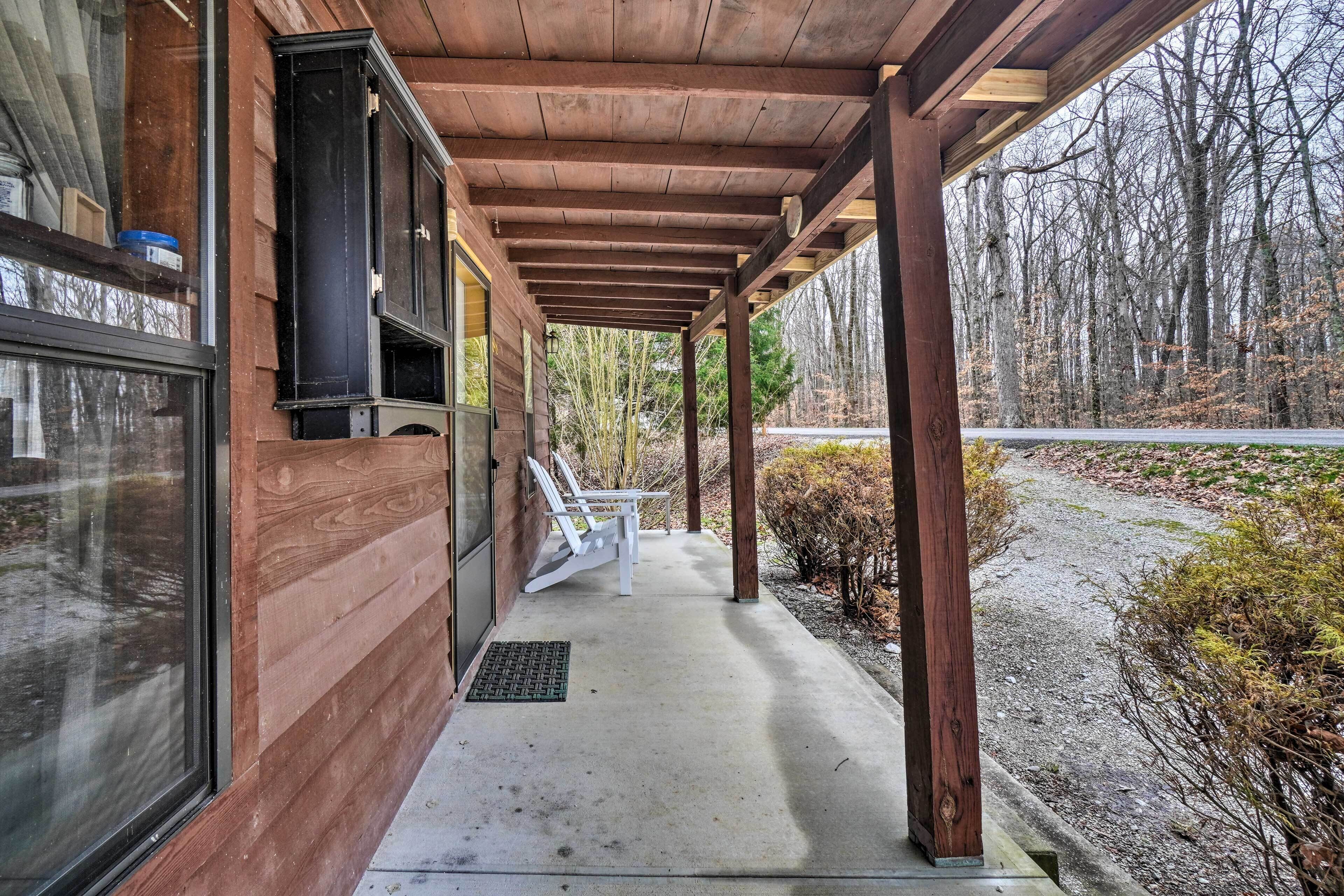 A wooden building with a covered porch, a window, and a door.