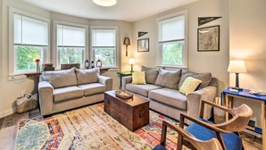 A cozy living room with two sofas, a coffee table, and a patterned rug. - Pet-friendly Saranac Lake Retreat w/ Deck & Yard (Saranac Lake)