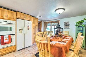 Enjoy meals in the kitchen with a dining area for four, featuring a table and chairs.