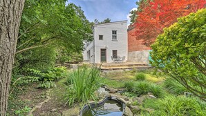 A house with a garden, a pond, and a patio area. - Historic Townhome in Downtown Shepherdstown! (Shepherdstown)