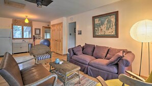 A living room with a sofa, armchairs, a coffee table, and a lamp. - Idyllic Northport Cottage, Walk to Lakeside! (Northport)