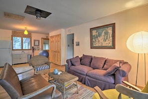 A living room with a sofa, armchairs, a coffee table, and a lamp. - Idyllic Northport Cottage, Walk to Lakeside! (Northport)