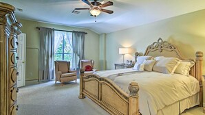 A bedroom with a large bed, a ceiling fan, a chair, and a dresser. - Home w/ Patio, Mins to Seaworld+lackland Afb! (San Antonio)