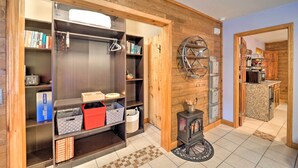 A modern kitchen with a wood-paneled wall, a built-in stove, and a kitchen island. - Steps to Beech Mountain Resort: Cozy Getaway (Banner Elk)