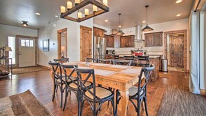 A spacious kitchen with wooden cabinets, a large island, and modern appliances. - Mccall Home + Hot Tub ~ 2 Mi to Payette Lake (McCall)