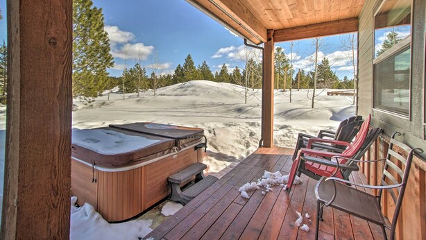 A wooden deck with a hot tub and chairs, overlooking a snowy landscape. - Mccall Home + Hot Tub ~ 2 Mi to Payette Lake (McCall)