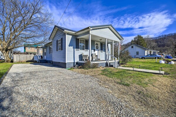 A single-story house with a porch, a gravel driveway, and a grassy yard. - Pet-friendly Charleston Home w/ Fenced Yard! (Charleston)