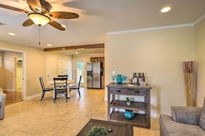 A spacious living room with a ceiling fan, a dining area with chairs and a table, a kitchen with a refrigerator, and a coffee table with a plant. - Pet-friendly Georgetown Home < 1 Mi to Dtwn! (Georgetown)