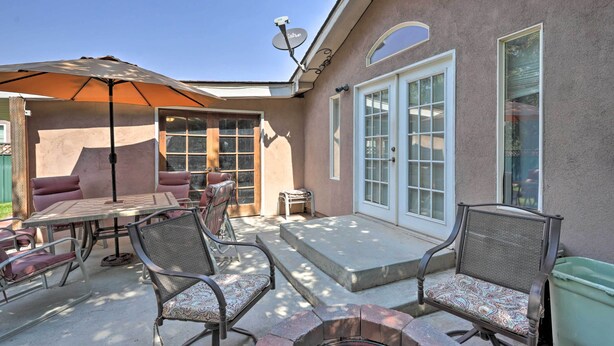 A patio with outdoor furniture, a fire pit, and a satellite dish. - 'red Rock Rambler' Moab Home w/ Hot Tub & Views! (Moab)