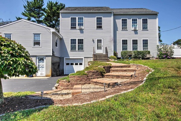 A two-story house with a front yard and a driveway. - South Kingstown Vacation Rental: 2 Mi to Beach! (South Kingstown)