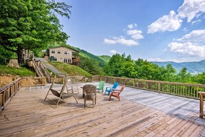 A wooden deck with outdoor furniture, a staircase leading to a house, and a view of green hills. - Private Blue Ridge Home w/ Hot Tub, Mountain Views (Marshall)
