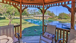 A wooden gazebo with a view of a swimming pool and a house in the background. - Pottsboro Home on 2 Acres w/ Hot Tub, Near Marina! (Pottsboro)