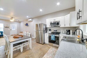 A modern kitchen with white cabinets, stainless steel appliances, and a granite countertop. - Pet-friendly Murray Vacation Rental w/ Grill! (Murray)
