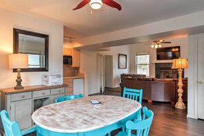 A dining area with a round table, blue chairs, and a ceiling fan. - Spacious Hideaway in Ruidoso w/ Multi-level Deck! (Ruidoso)