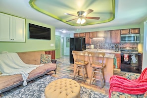 A kitchen with wooden cabinets, a refrigerator, and a microwave. - Tamaqua Apartment w/ Fire Pit & Gas Grill! (Tamaqua)