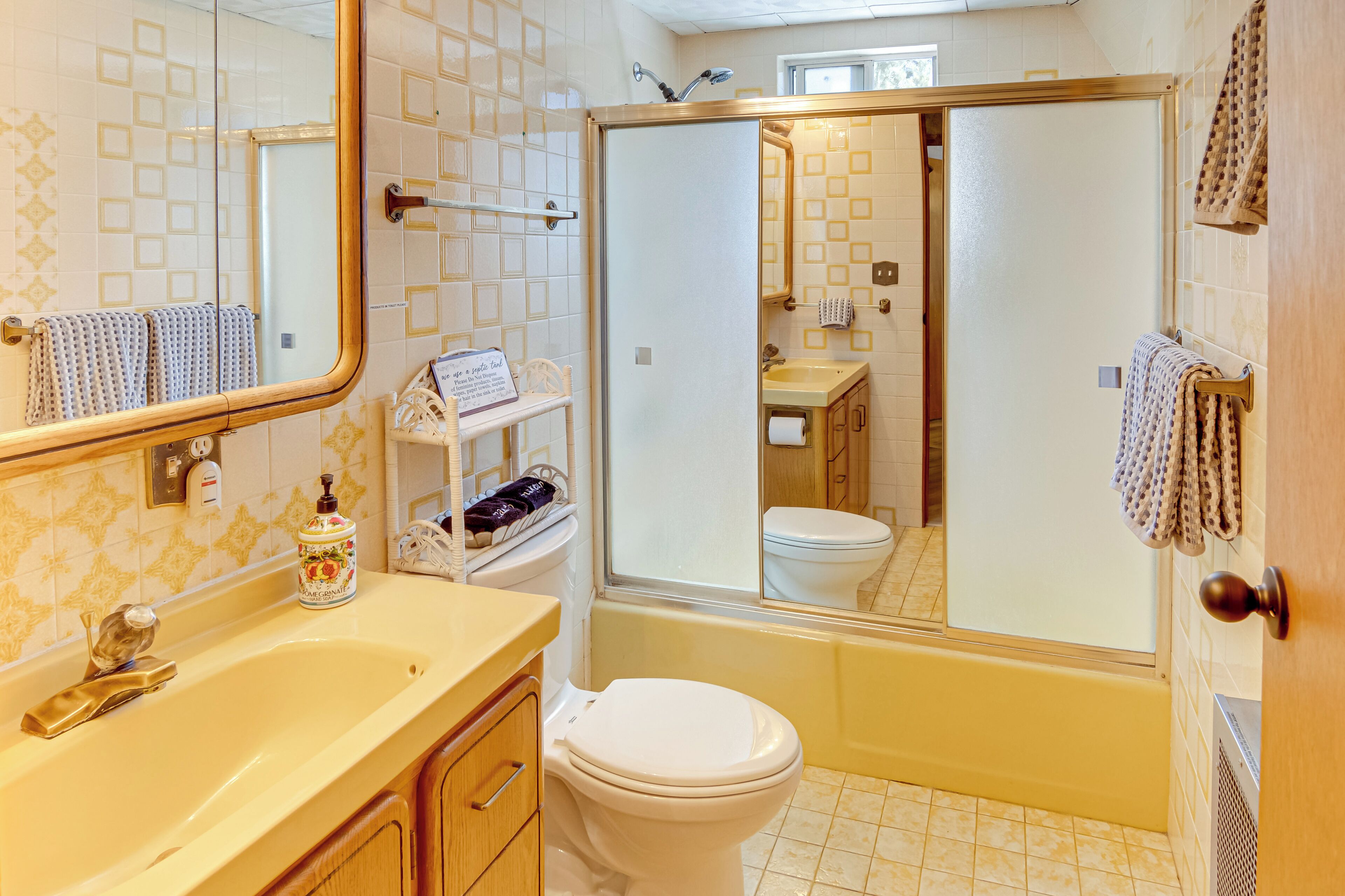 A bathroom with a bathtub, toilet, and sink.