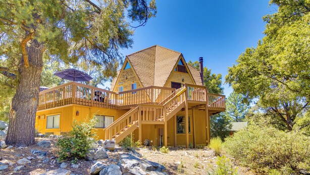 A wooden cabin with a balcony and a staircase, surrounded by trees and rocks. - 'star House' Unique Home w/ 360 Mountain Views! (Pine Mountain Club)