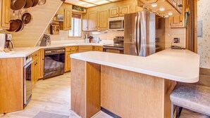 A modern kitchen with wooden cabinets, stainless steel appliances, and a large island. - 'star House' Unique Home w/ 360 Mountain Views! (Pine Mountain Club)