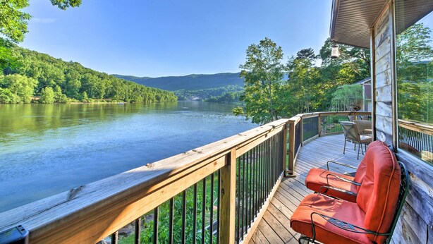 A wooden deck with a railing overlooking a river, surrounded by lush greenery and hills. - Tenn River Cabin w/ Hot Tub - 10 Mi to Chattanooga (Chattanooga)