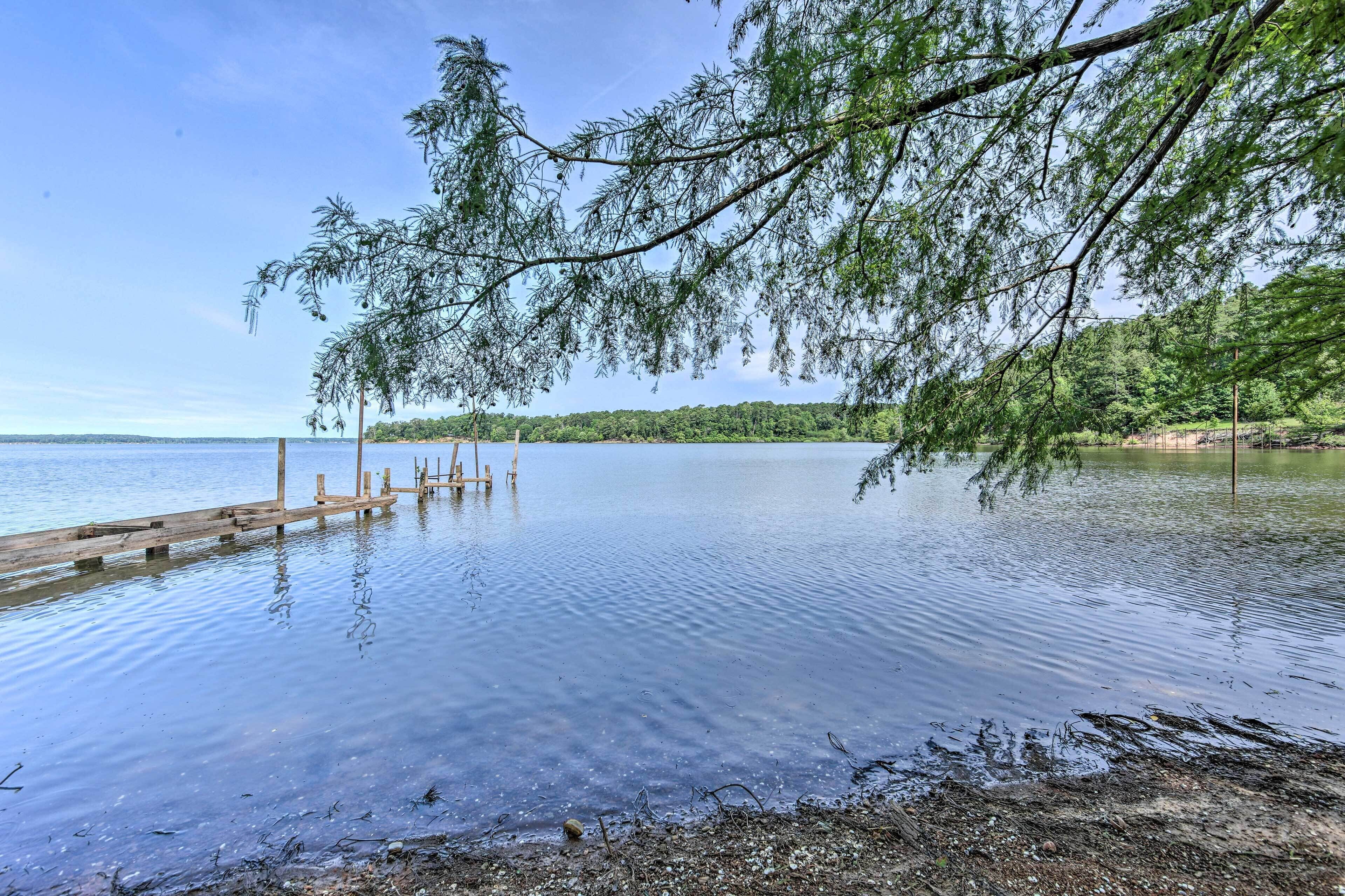 A calm lake with a wooden dock extending into the water.