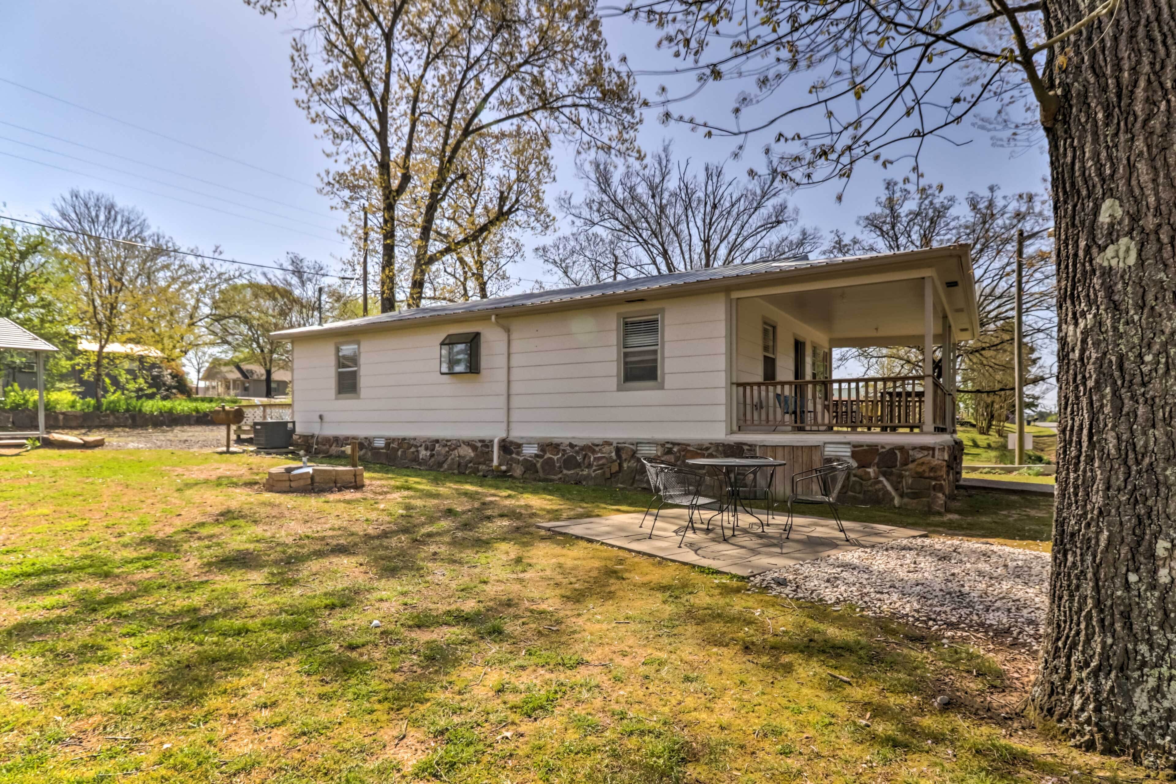 A single-story mobile home with a covered porch and a patio area.