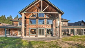 A large, multi-story log cabin with a prominent gable roof and large windows. - Brookings Vacation Rental Lodge on 88 Acres! (Brookings)