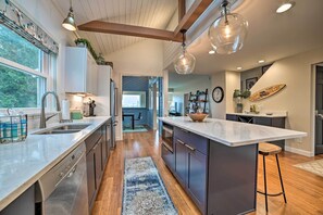 Enjoy cooking in this well-lit kitchen with ample workspace and a large window offering a view.