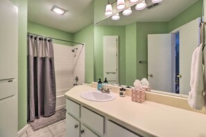 A bathroom with a white sink, green walls, a shower curtain, and a mirror. - Cozy Austin Area Home w/ Yard, 20 Mi to Dtwn! (Cedar Park)