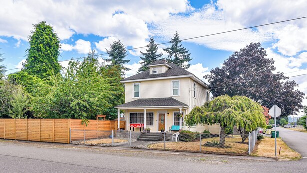 A two-story house with a front porch, a wooden fence, and a tree in front. - Walk to Crown Zellerbach Trl: PNW 'celestial Inn' (Scappoose)