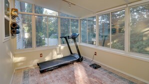 A home gym with a treadmill, large windows, and a skylight. - Beautiful Pet-friendly Washougal Home w/ Fire Pit! (Washougal)