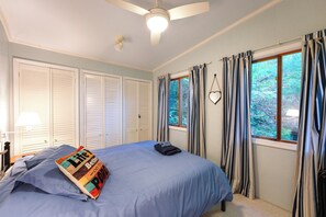 A bedroom with a bed, a ceiling fan, a window with curtains, and a view of greenery outside. - Family Friendly Mears Cottage - Walk to the Beach! (Mears)