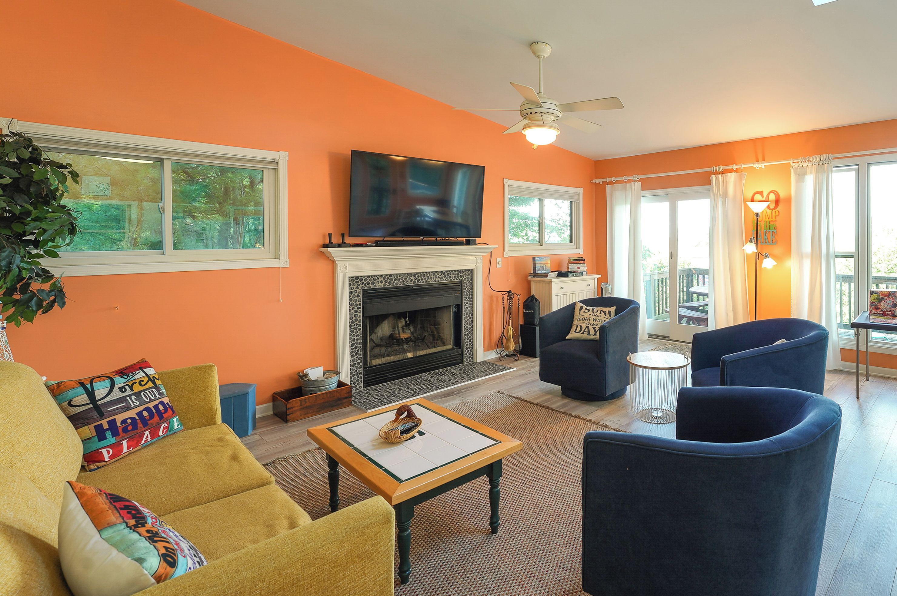 A living room with a fireplace, television, and seating area.
