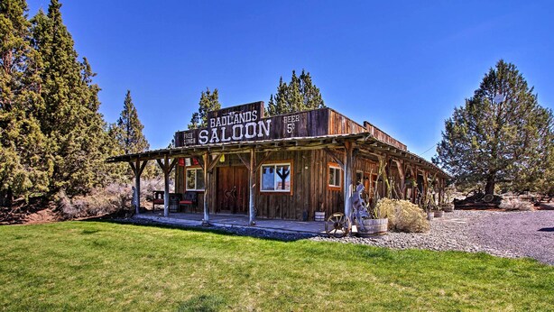 A rustic wooden building with a sign reading "Badlands Caloon" and a price tag of $5 for beer. - Dog-friendly Ranch Cottage w/ Yard ~ 13 Mi to Bend (Bend)