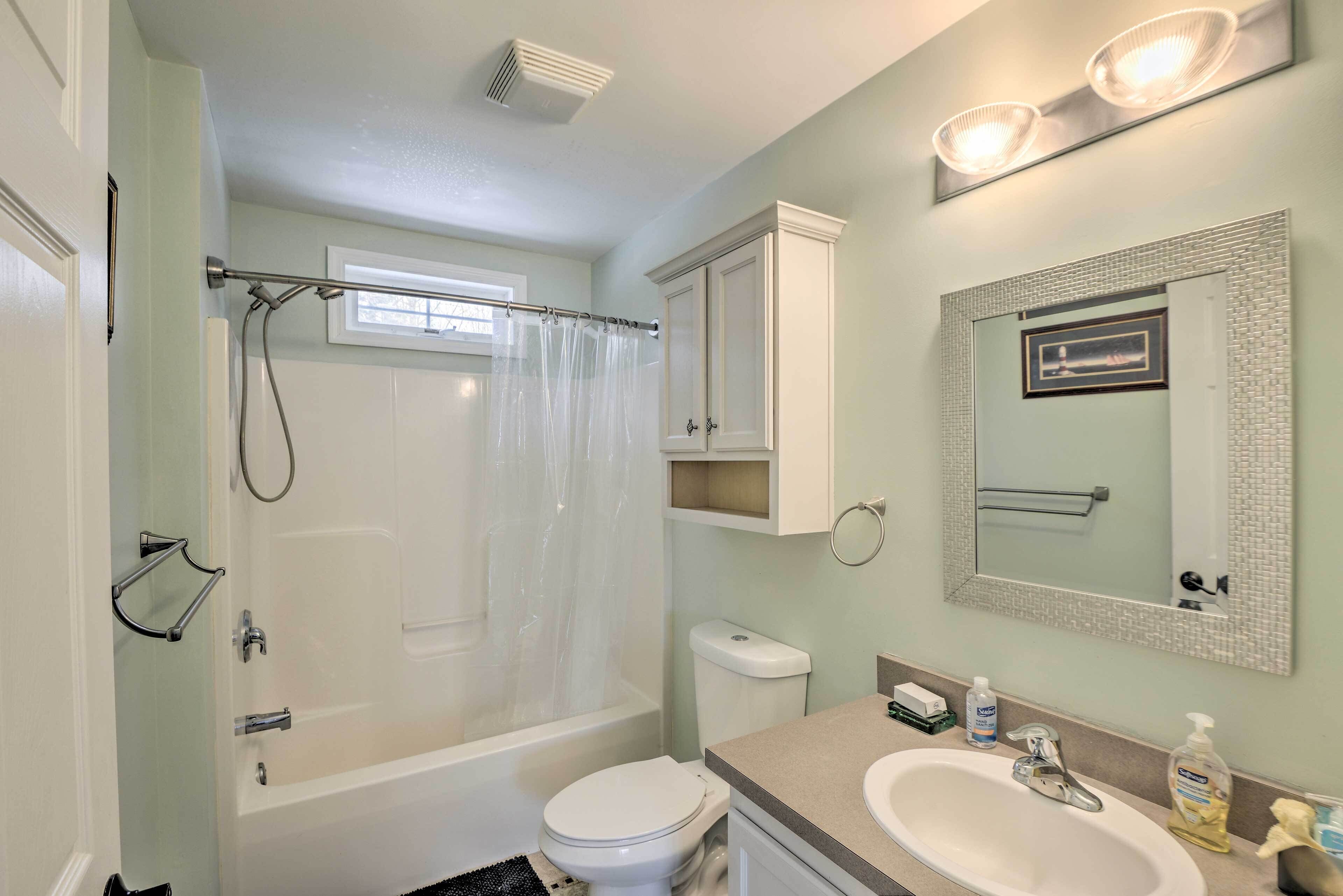 A bathroom with a bathtub, toilet, and sink.