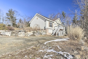 A two-story house with a front porch and a staircase leading to the second floor. - Idyllic Washington Retreat w/ Fire Pit & Yard (Washington)